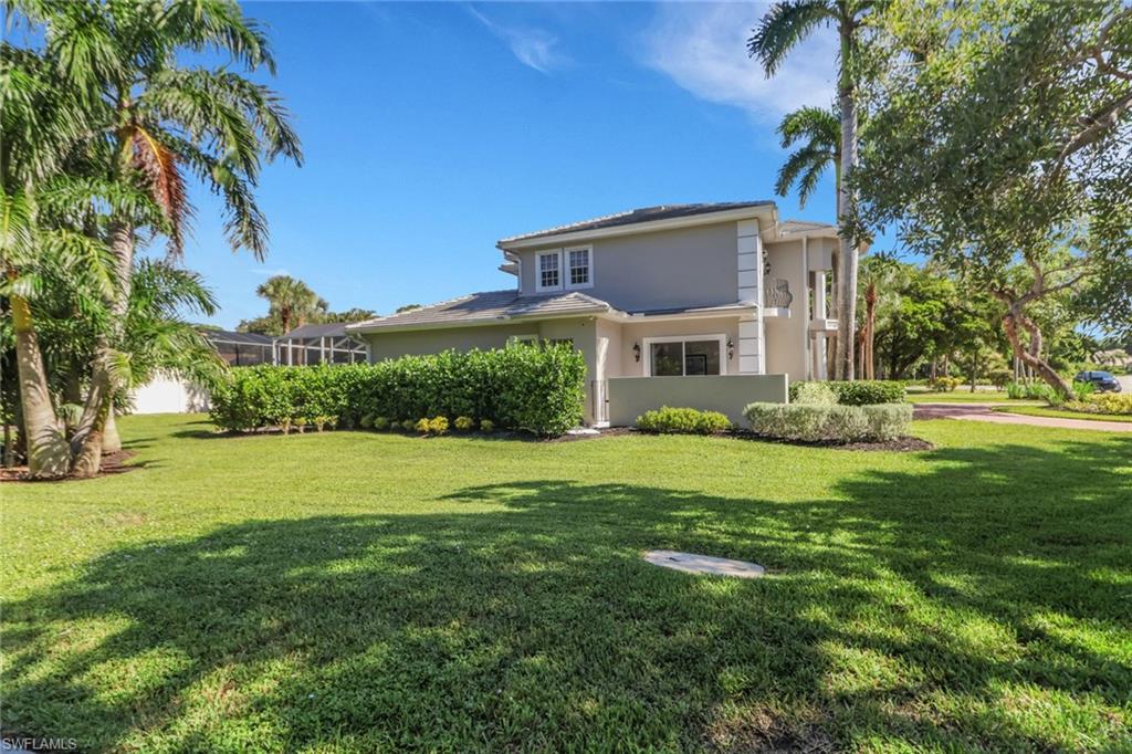 2127 Harlans Run Naples, FL 34105 - Photo 2 of 22 a front view of a house with a yard