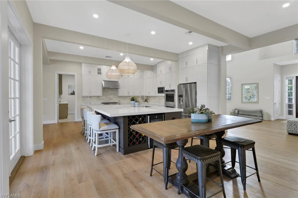 2127 Harlans Run Naples, FL 34105 - Photo 6 of 22 a view of a dining room with furniture and wooden floor
