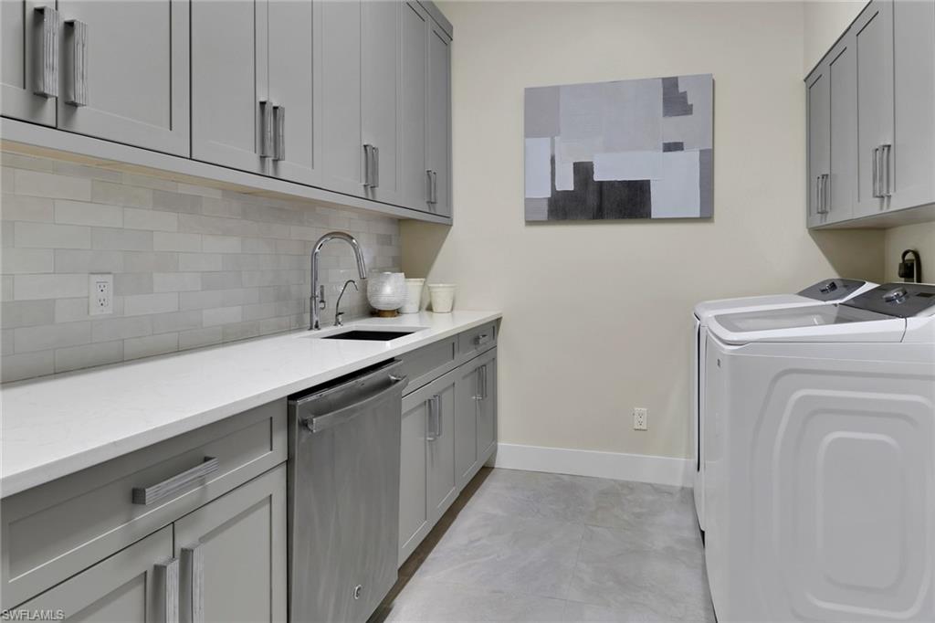 2127 Harlans Run Naples, FL 34105 - Photo 10 of 22 a kitchen with white cabinets and sink