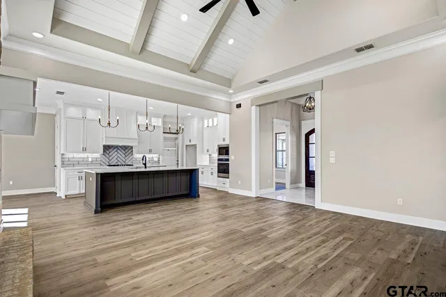 a large room with wooden floor and windows