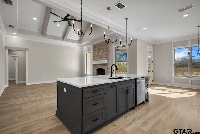 a kitchen with a sink a counter space and stainless steel appliances