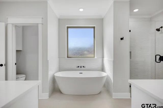 a white bath tub sitting next to a white sink