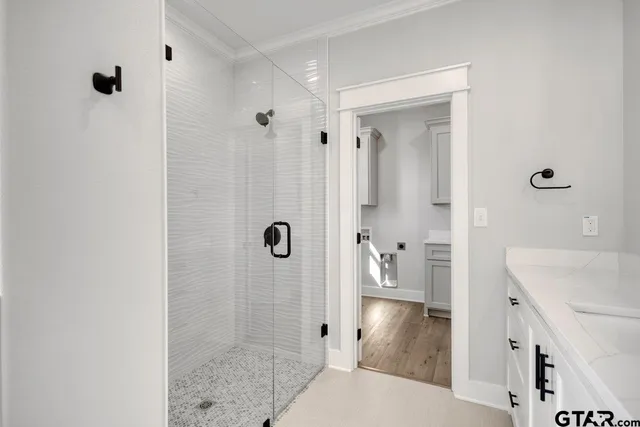 a bathroom with a tub shower and sink