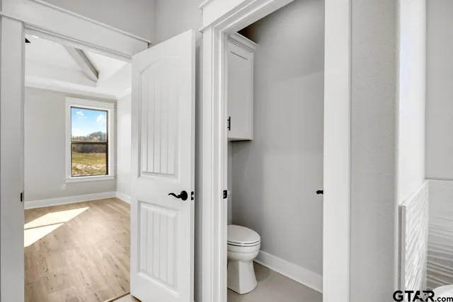 a white toilet sitting next to a bathroom sink
