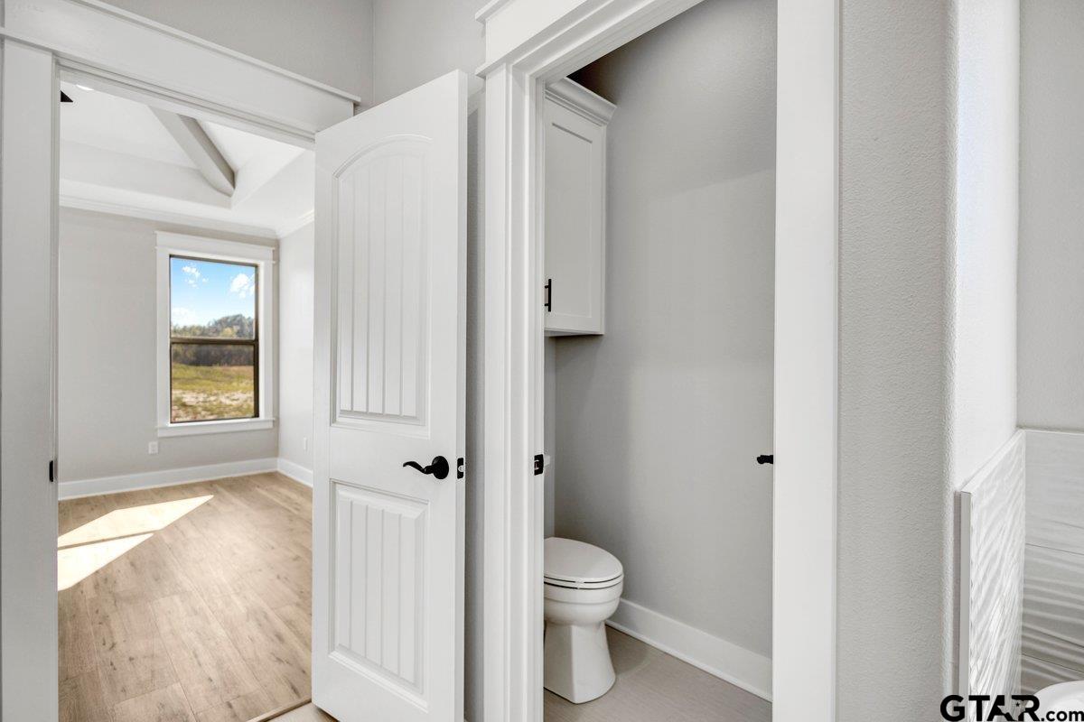 15531 Sugar Rdg Lane Flint, TX 75762 - Photo 30 of 45 a white toilet sitting next to a bathroom sink