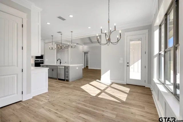 a view of a kitchen with wooden floor and windows