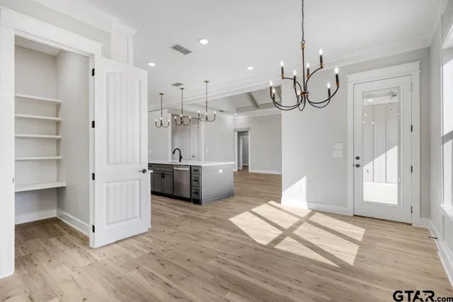a view of a kitchen with a sink a window and stainless steel appliances