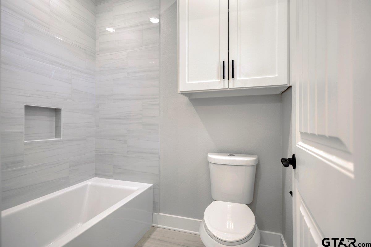 15531 Sugar Rdg Lane Flint, TX 75762 - Photo 41 of 45 a white toilet sitting next to a bathtub