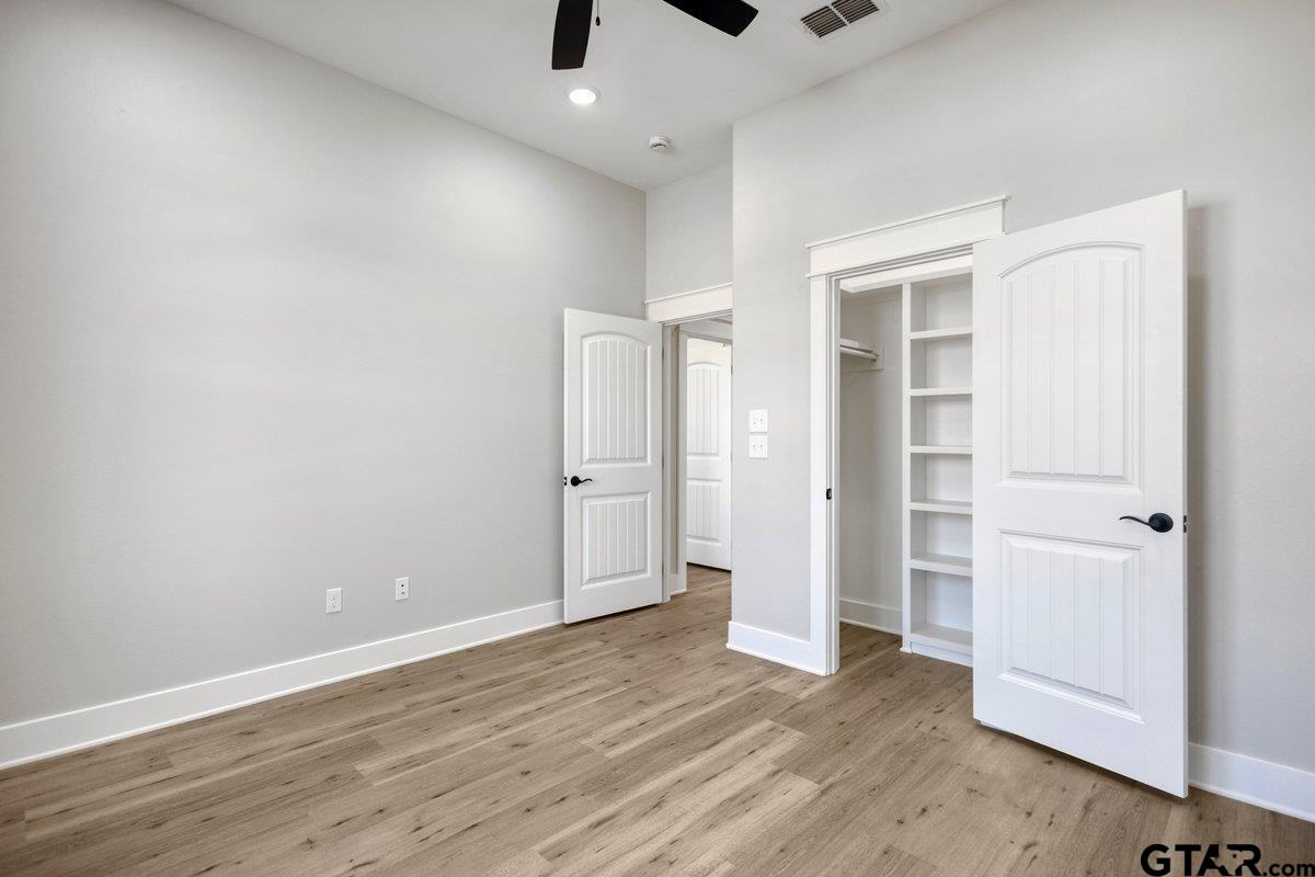 15531 Sugar Rdg Lane Flint, TX 75762 - Photo 44 of 45 an empty room with wooden floor closet and windows