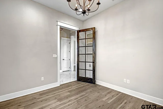 a view of a livingroom with a ceiling fan and wooden floor