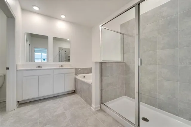 a bathroom with a shower sink and mirror