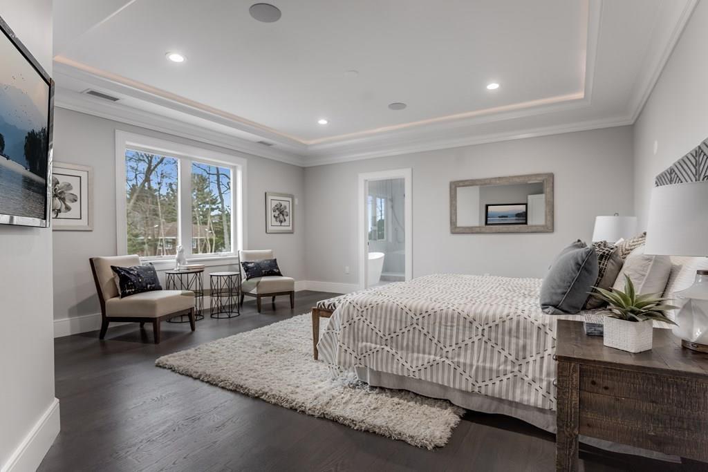 819 Dedham Street Newton, MA 02459 - Photo 23 of 40 a bedroom with a bed and large windows