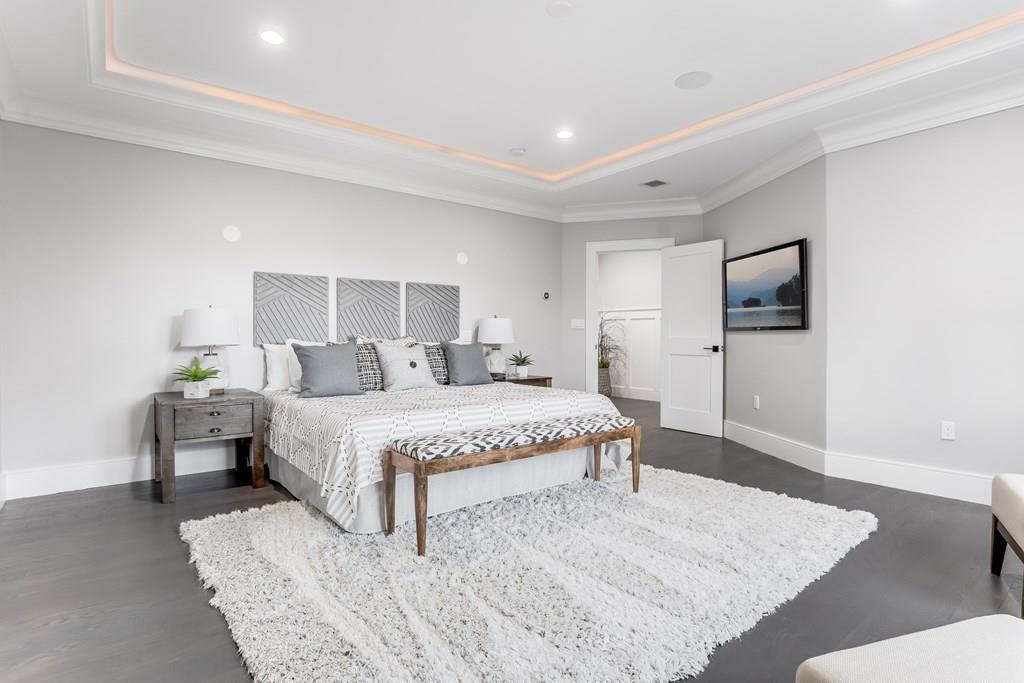 819 Dedham Street Newton, MA 02459 - Photo 24 of 40 a spacious bedroom with a bed and a couch