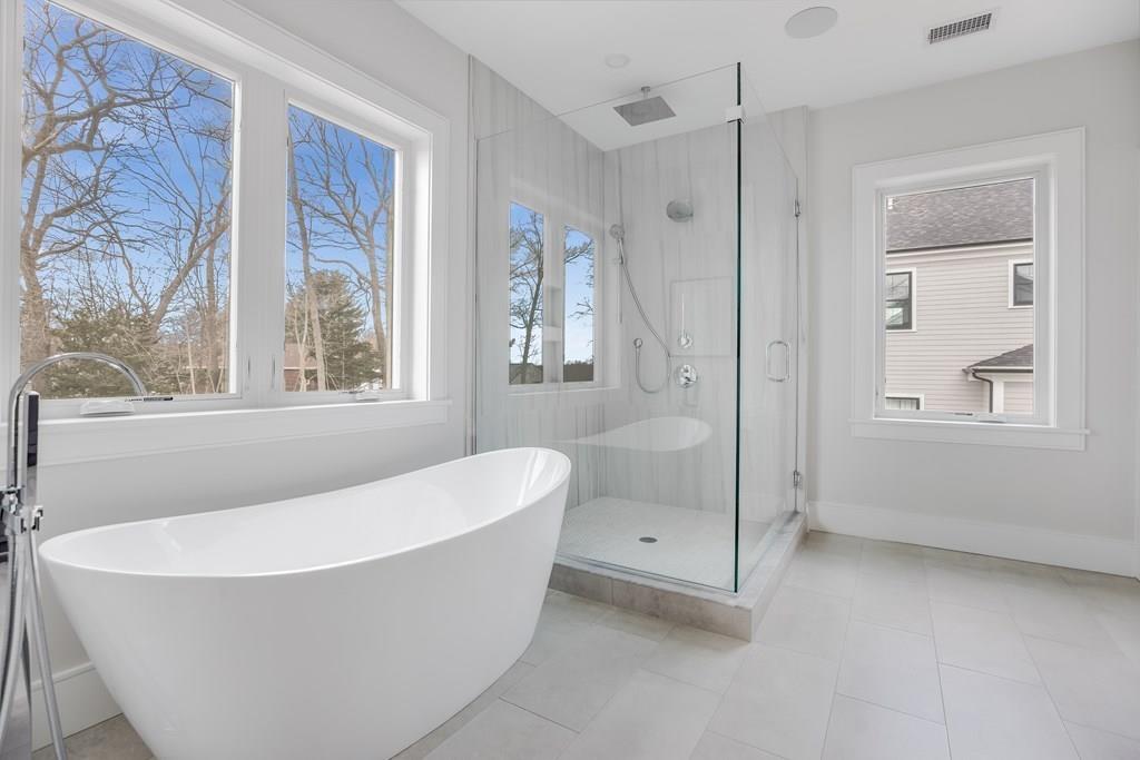 819 Dedham Street Newton, MA 02459 - Photo 26 of 40 a white bath tub sitting in a bathroom