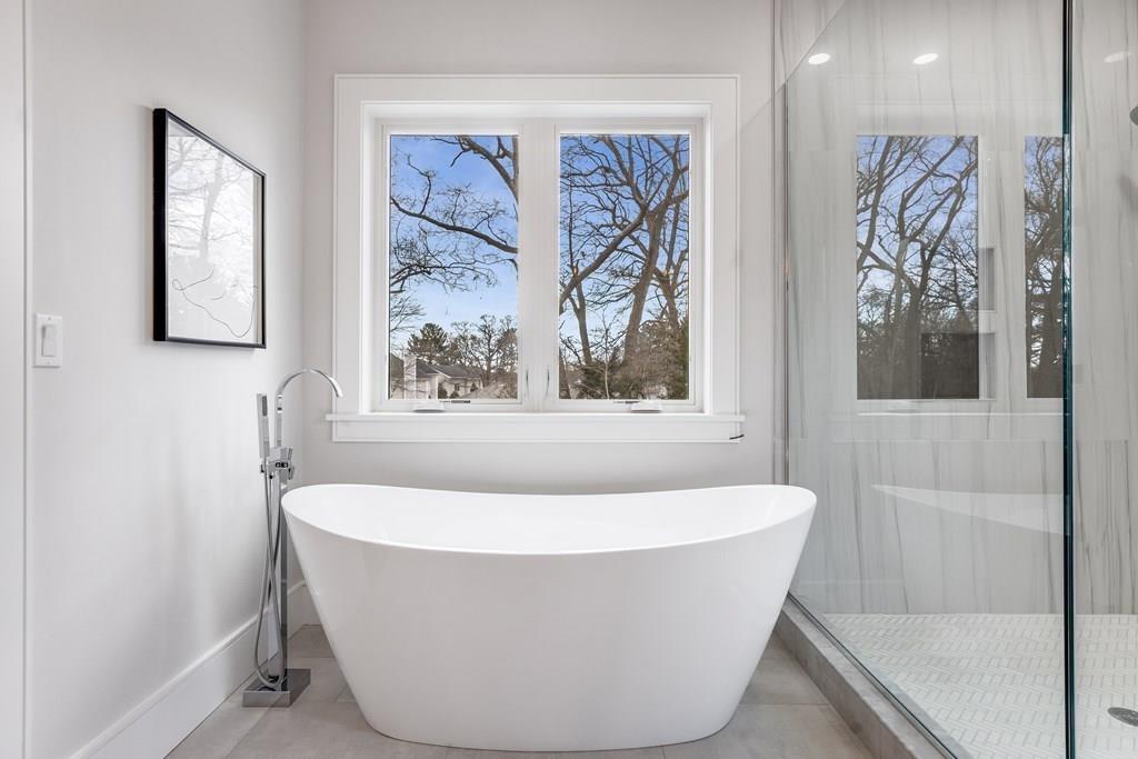 819 Dedham Street Newton, MA 02459 - Photo 27 of 40 a white bath tub sitting in a bathroom