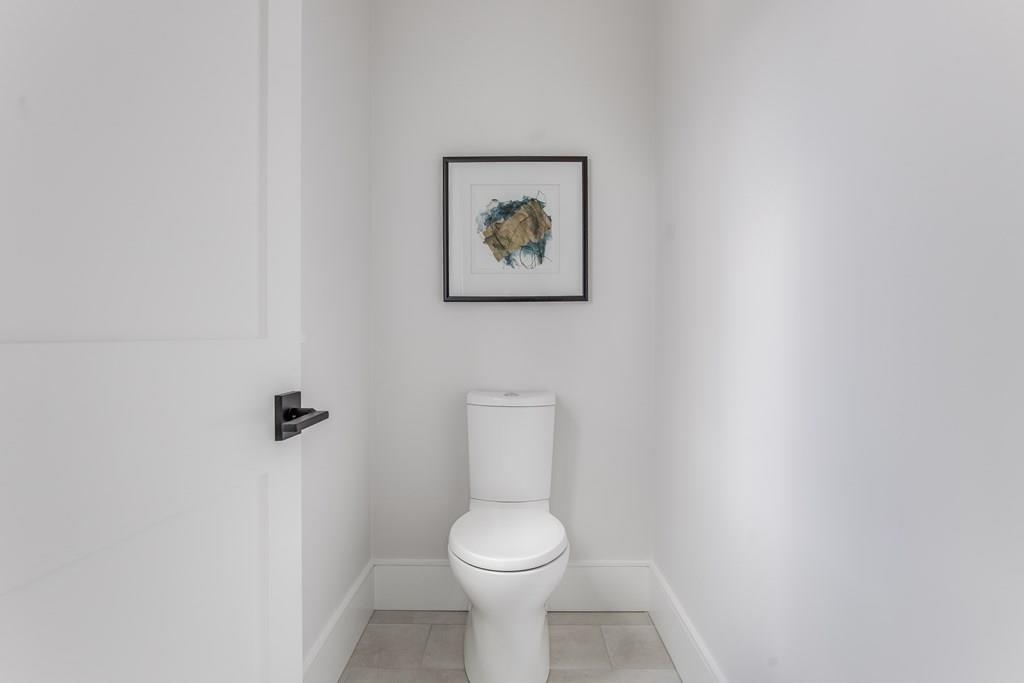 819 Dedham Street Newton, MA 02459 - Photo 28 of 40 a white toilet sitting in a bathroom next to a white wall