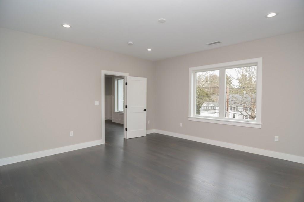 819 Dedham Street Newton, MA 02459 - Photo 30 of 40 an empty room with wooden floor and windows