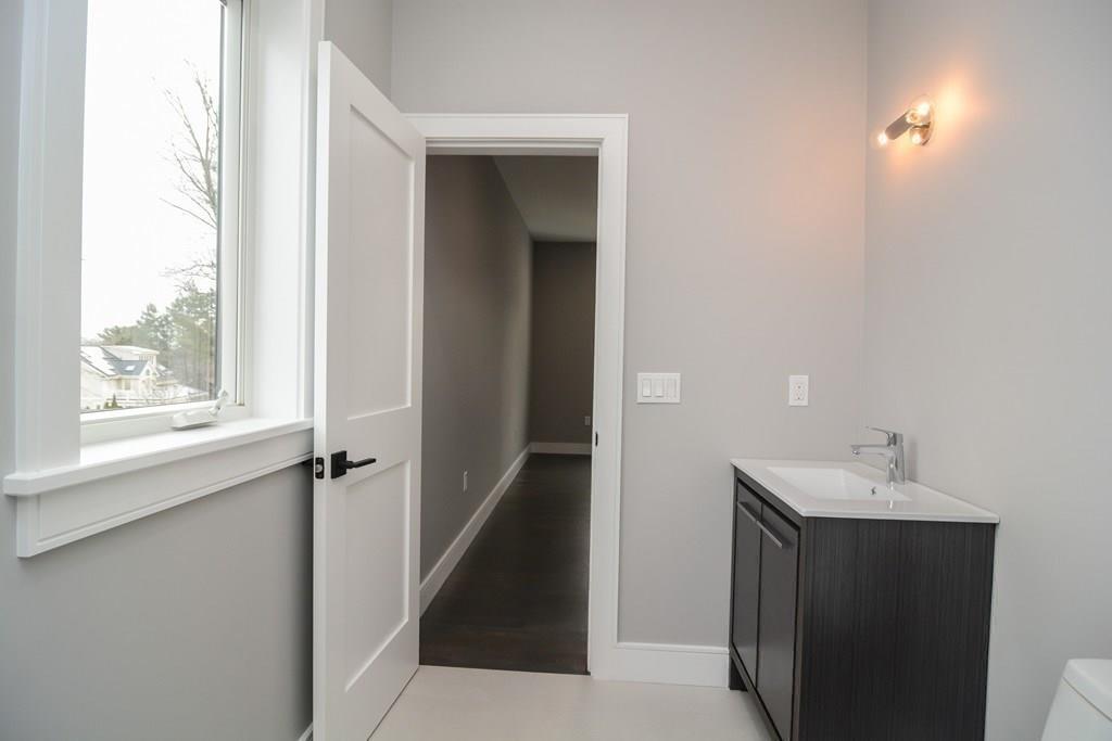 819 Dedham Street Newton, MA 02459 - Photo 32 of 40 a bathroom with a sink and mirror