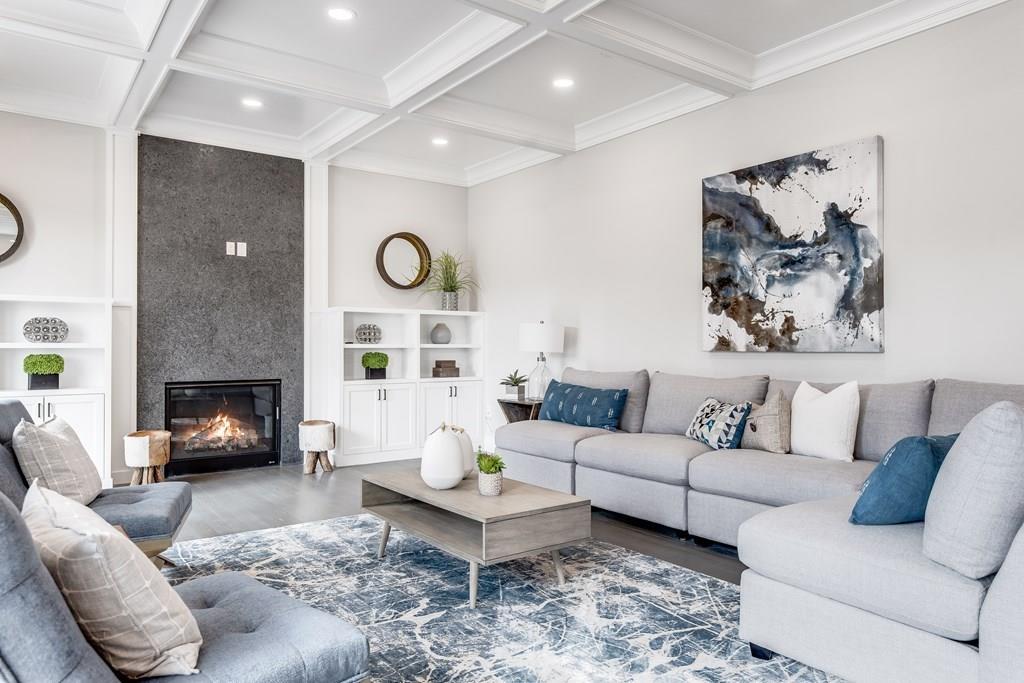 819 Dedham Street Newton, MA 02459 - Photo 10 of 40 a living room with furniture a fireplace and a wall painting