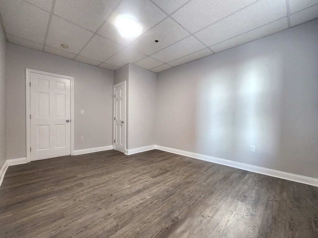 178 High Street, Unit 304 Clinton, MA 01510 - Photo 11 of 24 a view of an empty room with wooden floor