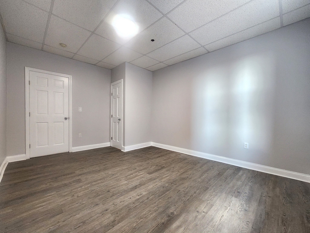 178 High Street, Unit 304 Clinton, MA 01510 - Photo 15 of 26 a view of an empty room with wooden floor