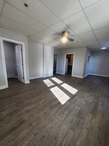 a view of empty room with wooden floor