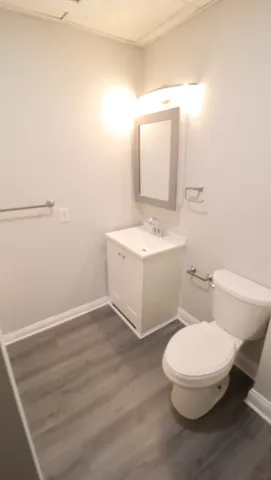 a white toilet sitting next to a bathroom sink