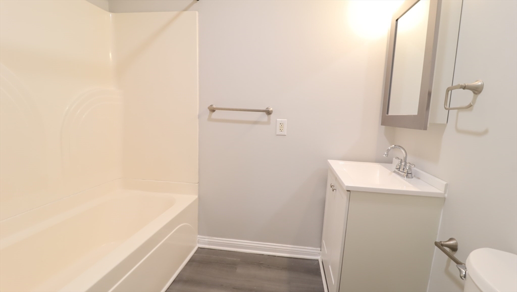 178 High Street, Unit 304 Clinton, MA 01510 - Photo 18 of 26 a bathroom with a sink and a mirror