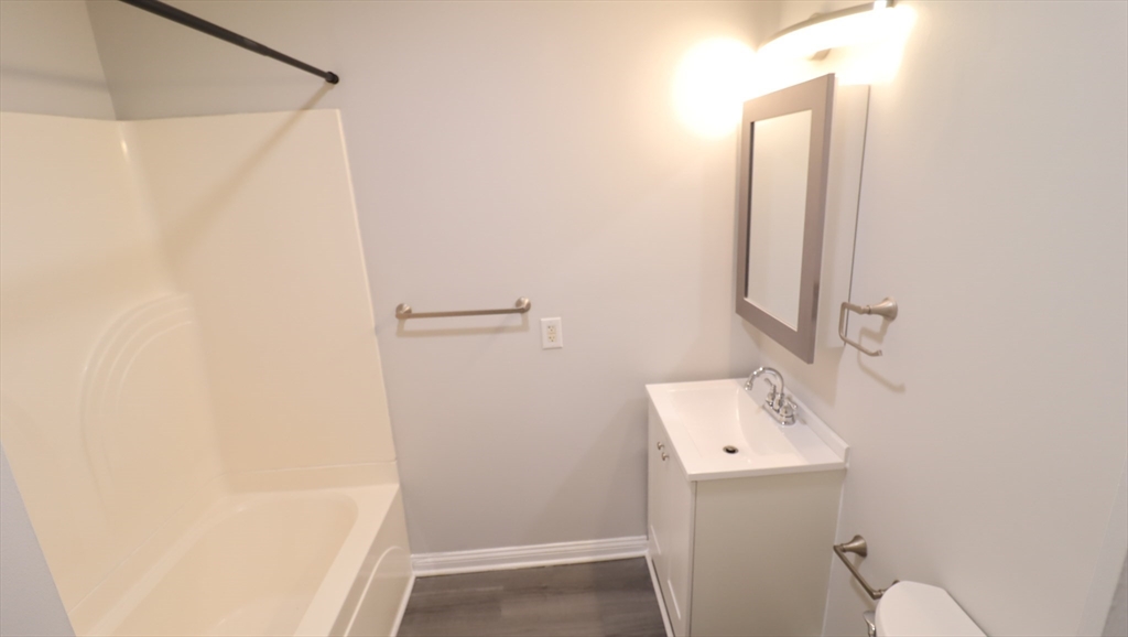 178 High Street, Unit 304 Clinton, MA 01510 - Photo 19 of 26 a bathroom with a sink a toilet and shower