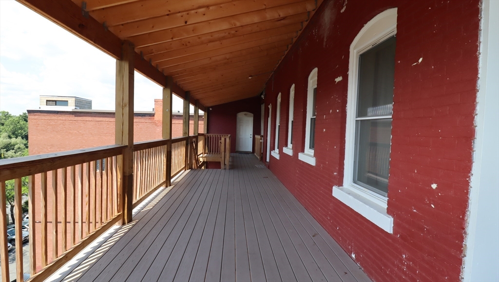 178 High Street, Unit 304 Clinton, MA 01510 - Photo 23 of 26 a view of a balcony with wooden floor