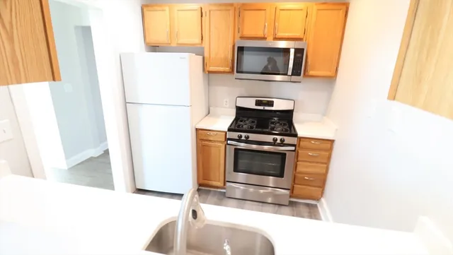 a kitchen with a refrigerator stove and microwave