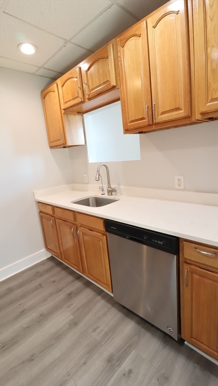 178 High Street, Unit 304 Clinton, MA 01510 - Photo 4 of 24 a kitchen with stainless steel appliances granite countertop a sink a microwave cabinets and a wooden floor