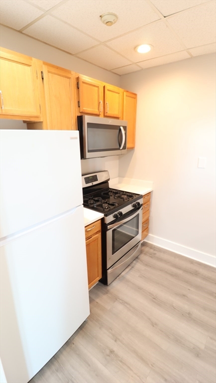 178 High Street, Unit 304 Clinton, MA 01510 - Photo 5 of 26 a kitchen with stainless steel appliances a refrigerator and a stove