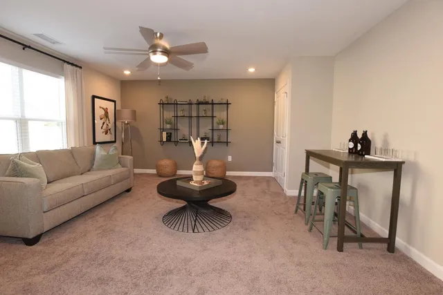 a living room with furniture and a wooden floor