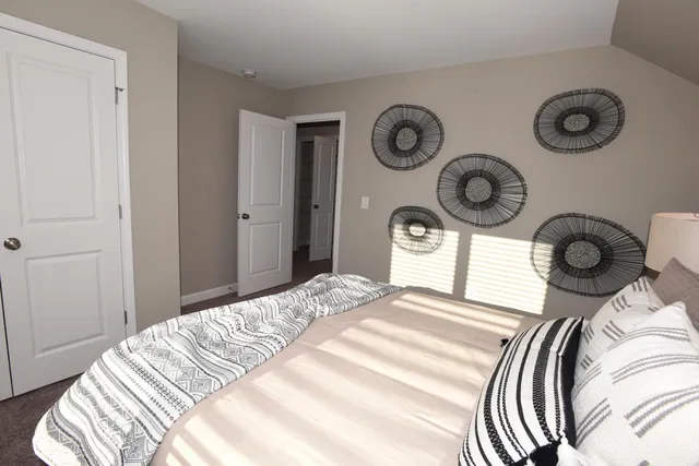 a bedroom with a bed and a clock on the wall