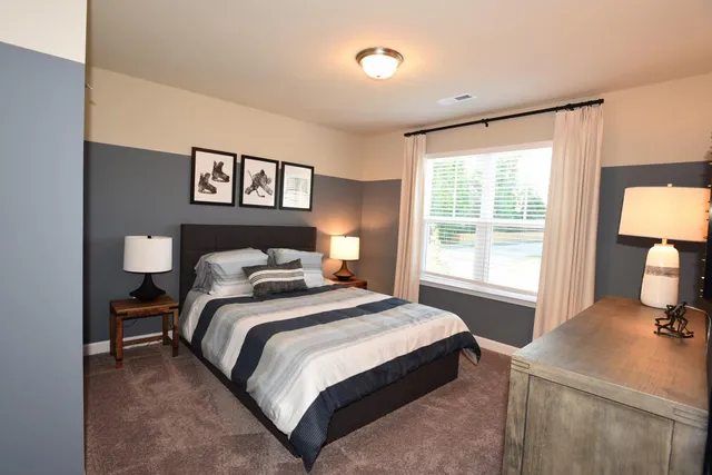 a bedroom with a bed and a a table in it