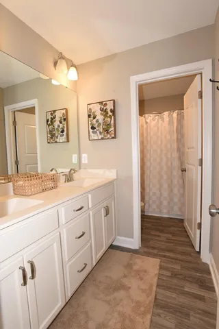 a spacious bathroom with a granite countertop sink mirror and a