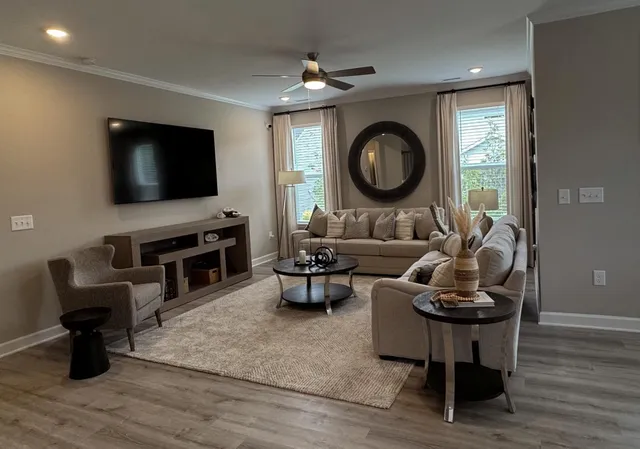 a living room with furniture and a flat screen tv