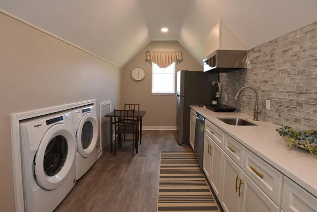 a kitchen with sink a washer and dryer