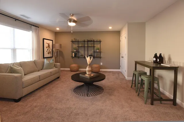 a living room with furniture and a large window