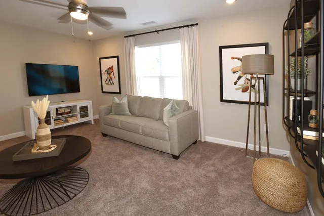 a living room with furniture and a flat screen tv