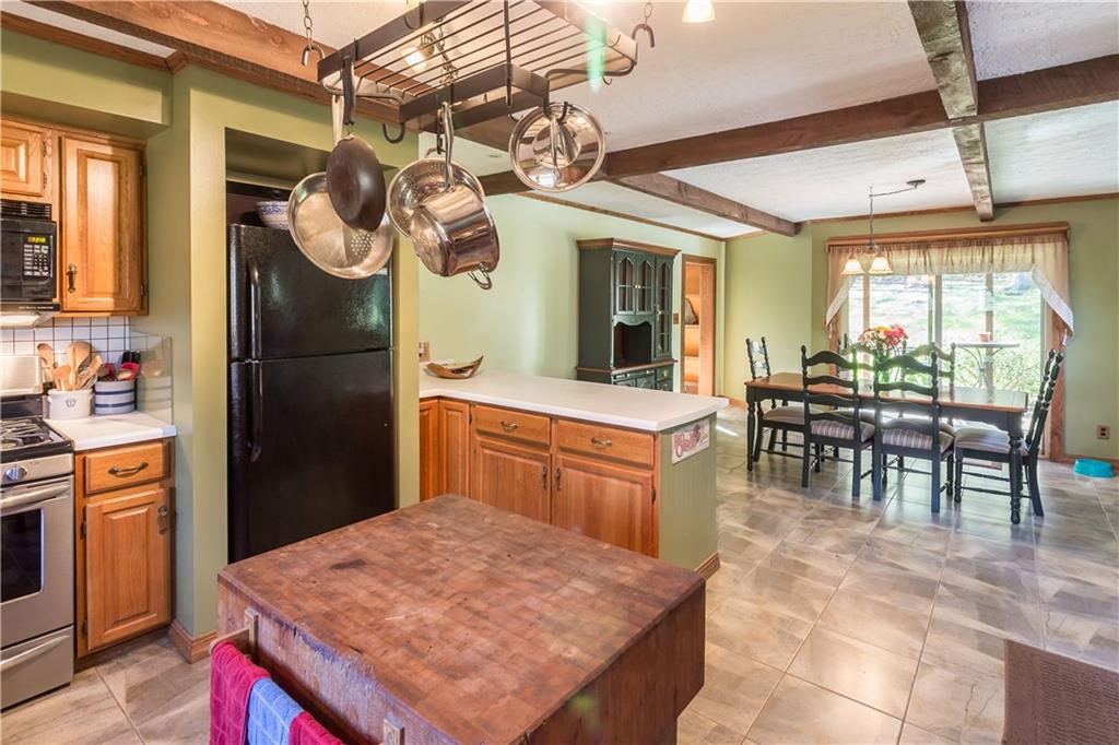 339 Cottage Road Clinton, PA 15026 - Photo 5 of 25 Peninsula eat at bar separates the kitchen from dining room. Notice the ceiling beams, they are solid wood