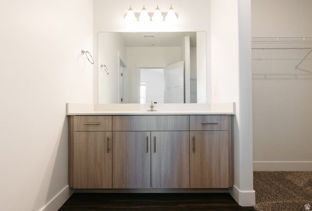 4655 South 720 West, Unit I304 Mapleton, UT 84664 - Photo 5 of 16 Bathroom with vanity, a spacious closet, and dark wood-style floors