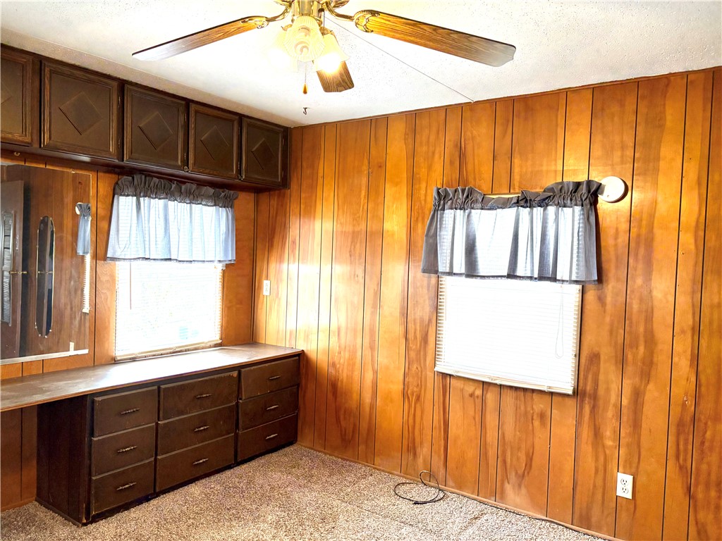 5434 North Waynesville Road, Unit 15 Oregonia, OH 45054 - Photo 4 of 19 This cozy bedroom features paneling and carpet, with built-in storage solutions and ample natural light.
