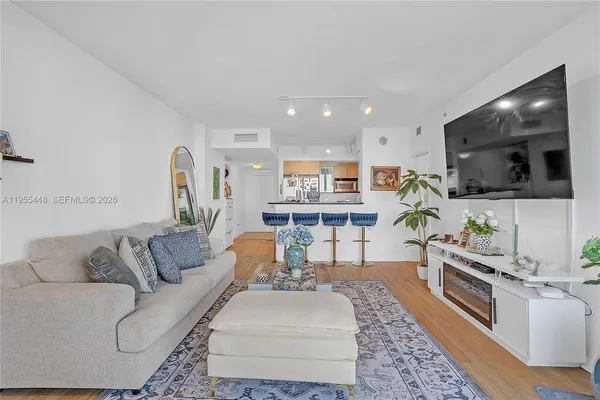 a living room with furniture and a flat screen tv