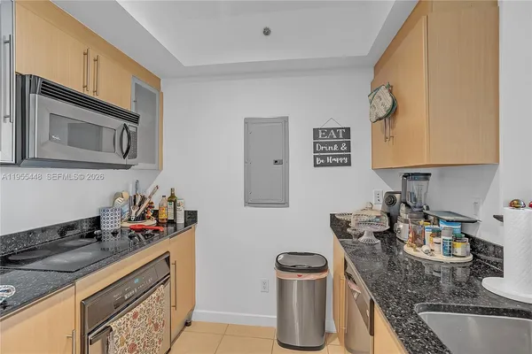 a kitchen with granite countertop a sink and a stove top oven