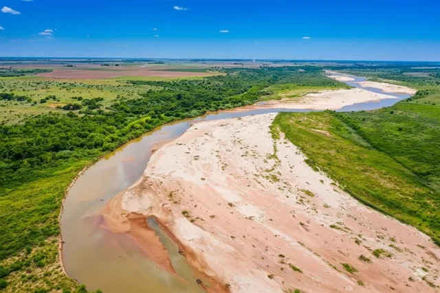 a view of a swimming pool with a yard
