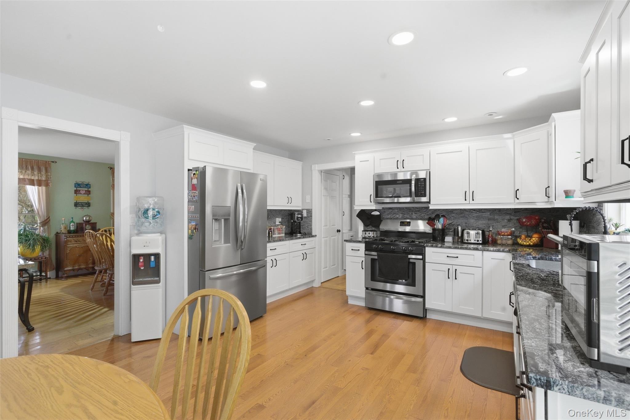 1285 Lakes Road Monroe, NY 10950 - Photo 6 of 45 a kitchen with stainless steel appliances granite countertop a refrigerator and stove top oven