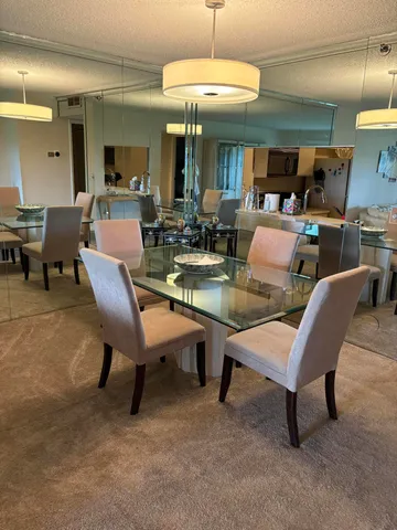 a large kitchen with kitchen island granite countertop a sink and a white cabinets
