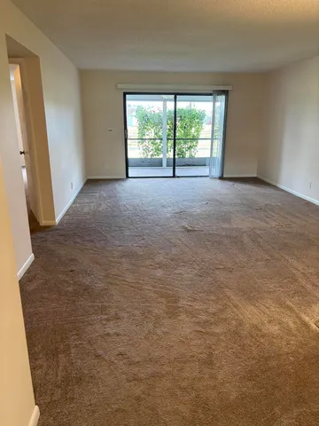a living room with lots of furniture and a wooden floor